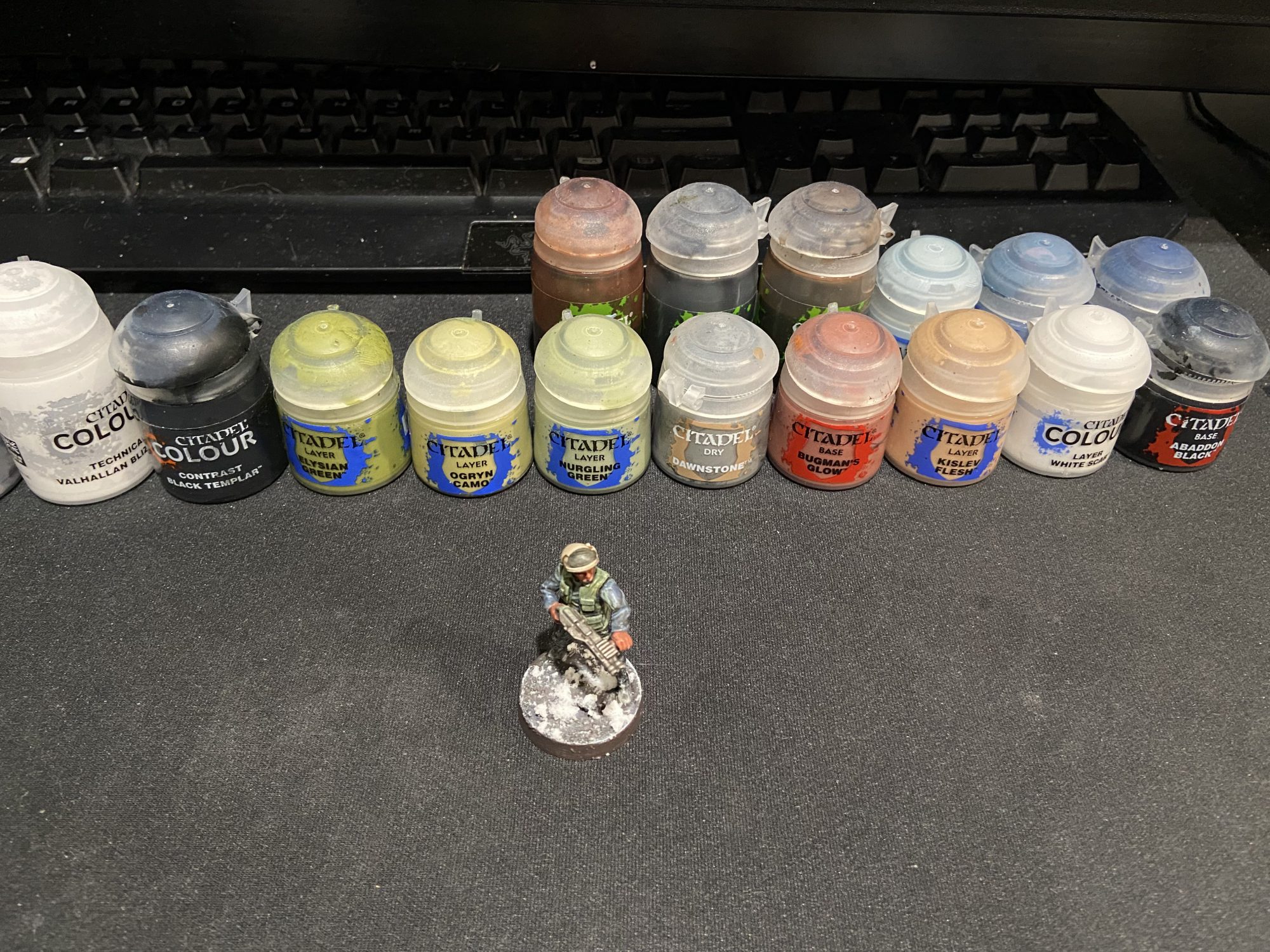 A Star Wars Legion Rebel with a green jacket and blue under layer, the base is covered in snow. Credit Jon.Kil