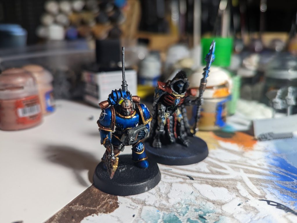 Ultramarines Master of Signal Consuil with Legatine Axe and Ultramarines Armistos Consul with Empathetic Obliterator.