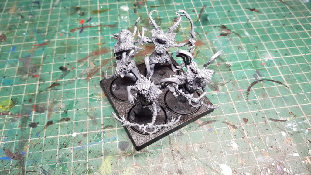 Four unpainted Kern Skirmishers, ranked up.