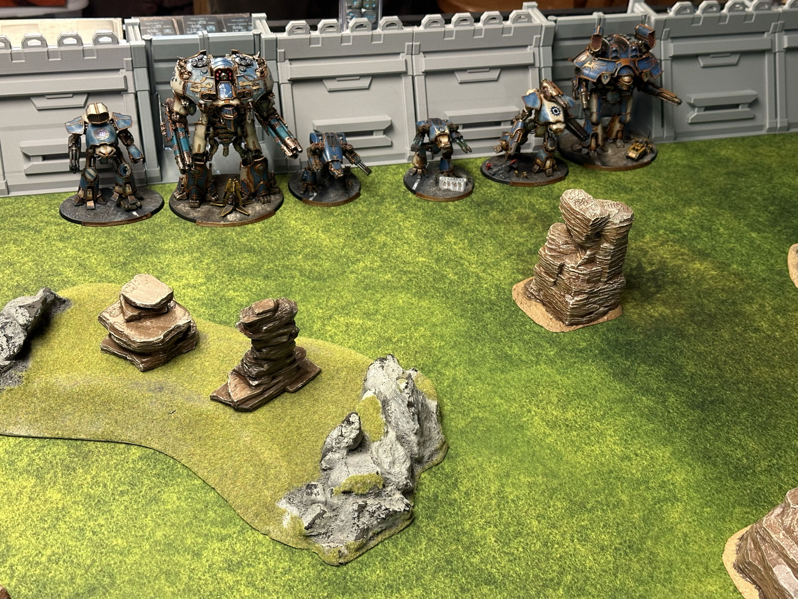 Titans arrayed in front of a wall