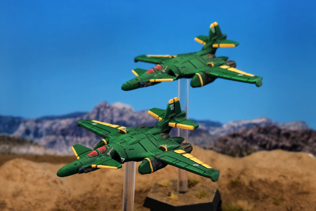A pair of Visigoth fighter jets, painted green with yellow trim.
